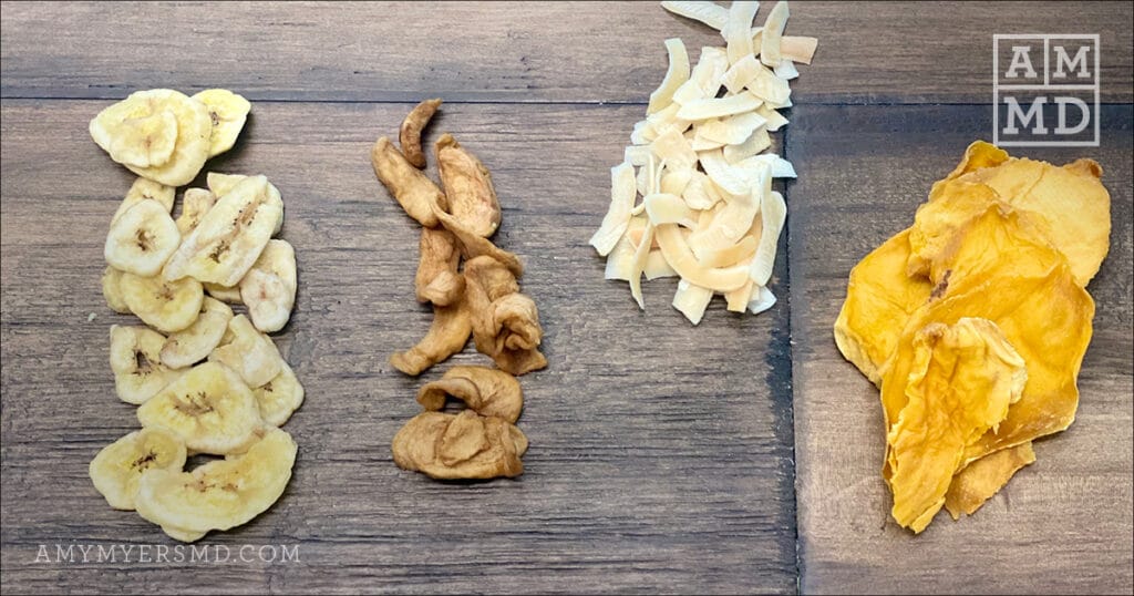 Various rows of dried fruit including bananas, mangos, apples, and toasted coconut chips