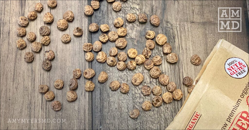 Nut and gluten-free tiger nits being poured out of a bag onto a wooden table