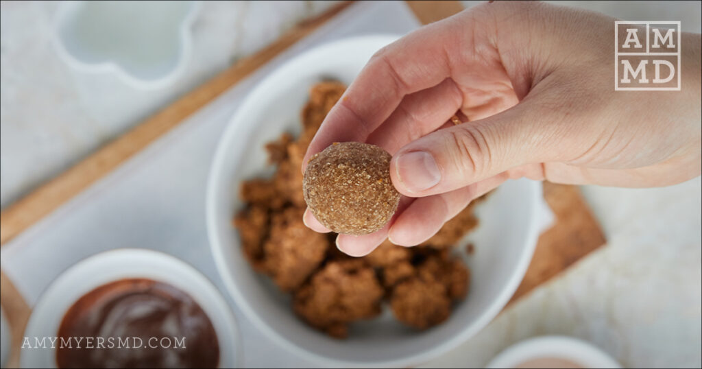 Holding brownie bite - - Collagen Probiotic No Bake Brownie Bites - Amy Myers MD®